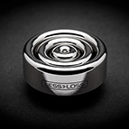 The Blackbody v.2 is a disc-shaped metal object. It is 54mm in diameter and 18.5mm in height.