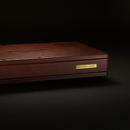 The <b>BlackGround 10x Power Base</b> features a lacquered wooden enclosure and hand finished brass placard on its front. 