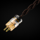 The state-of-the-art C-MARC™ <b>Classic</b> <i>Entropic Process</i> power cable can be ordered with the wall plug option to fit your country's standard. Pictured above is the CEE 7/4 (German “Schuko” 16 A/250V earthed) standard, ready to accept the ground pin protruding from wall plugs in such countries as Belgium and France. The power’s “phase,” or “Live” connection should enter the plug into the leg which has a red mark, visible inside the clear housing of the connector. This way, the Live signal comes out of the proper hole on the C13 equipment end connector according to IEC standard. <i>Entropic Process</i> insignia are attached to the internal wall of the transparent housing. These are non-removable.